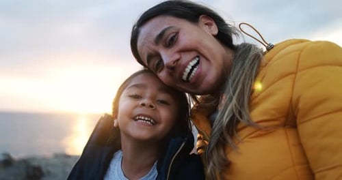 Smiling woman and child at scenic sunset