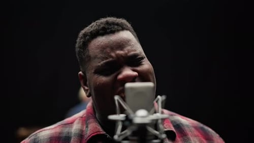 Male Singer Performing With Microphone in Studio