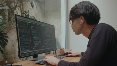 Software Developer Writing Computer Code on PC