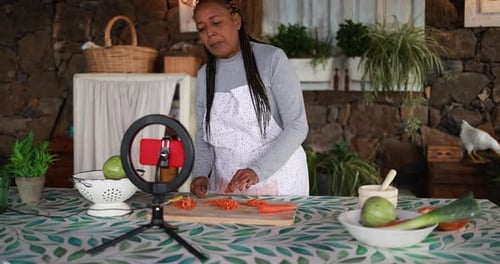 Woman Chopping Carrots on Camera for Online Video