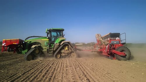 Tractor on the field seeding wheat