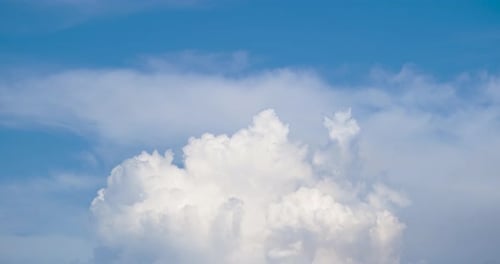 Fluffy White Clouds Drifting in a Blue Sky