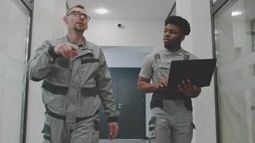 Men Install CCTV Cameras in Office Hallway