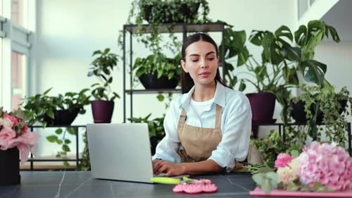 Woman Working on Laptop in Flower Shop