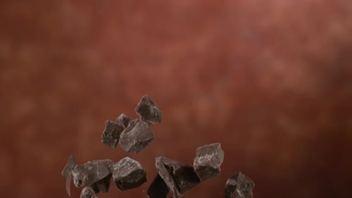 Chunks of Chocolate Floating in Air on Brown Background