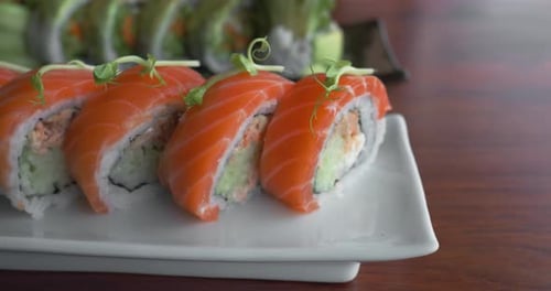 Sushi Set Japanese Meal on Plate Row of Red Sushi Decorated with Greenery on Top Serving Rolls on