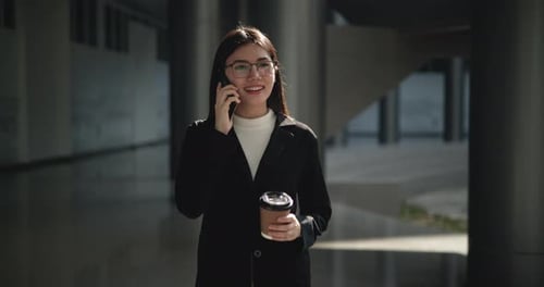 Smiling Woman Talking on Phone with Coffee