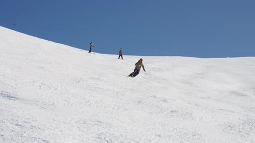 Skier Glides Down Snowy Mountain on Sunny Day