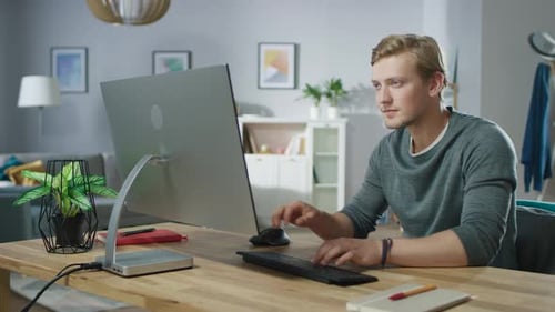 Young man working on a computer at home