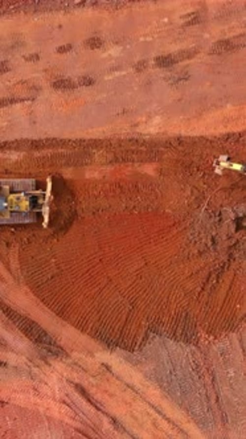 Aerial view of Bulldozer Leveling Red Soil