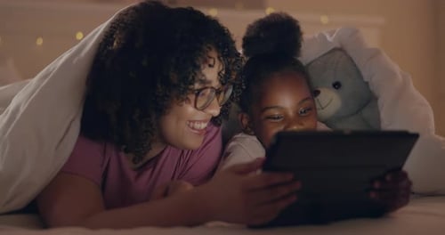 Mother, girl and tablet in bed, night and blanket for talking, thinking