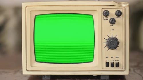 Old small vintage TV. 70s style television on vintage table. Gren screen with old TV screen effect.