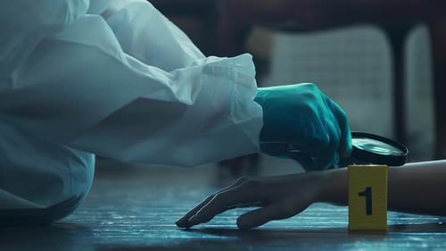 Investigator Examines Hand with Magnifying Glass at Crime Scene