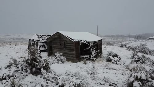 Drone Footage Of Abandoned Rustic Building In The Snow