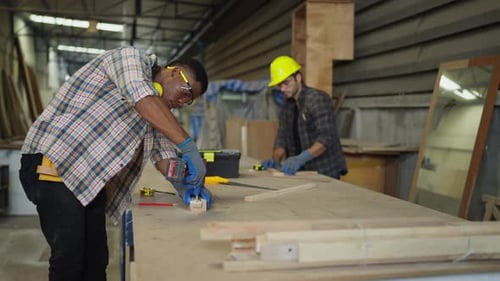 Men working with wood inside a workshop