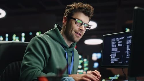 Smiling Analyst Typing Keyboard Desktop Computer in Data Center Room Closeup