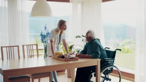 Woman and senior man talking at a table