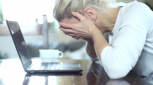 Woman Frustrated While Using Laptop at Home