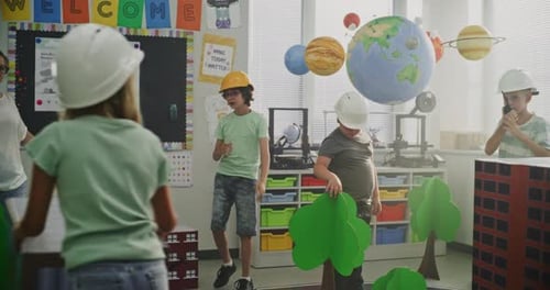 Smart Young Kids in Hardhats Creating Interactive Urban Planning with Big Cardboard City Models