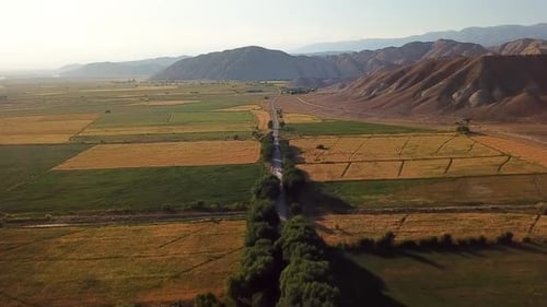 Aerial view of road surrounded with mountains