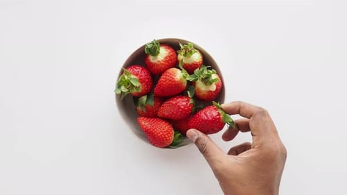 Top View of Hand Pick Ripe Red Strawberries in a Bowl on Table