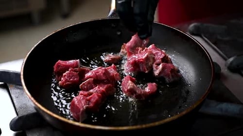 Meat Cooking in Frying Pan on Gas Stove