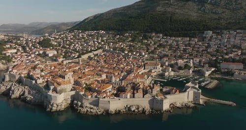 Aerial 5K Drone Around Historic Fortress Wall And Waterfront City Of Dubrovnik Croatia On Sunny Day