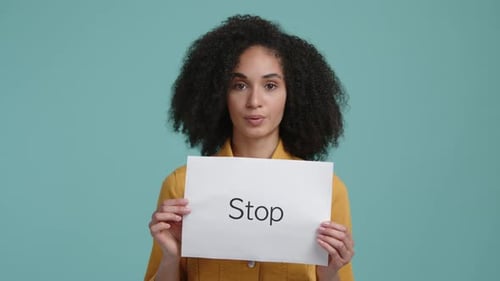 Young Woman Holds Stop Sign