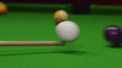 Closeup of White and Blue Billiard Balls Cue Hits White One and It Knocks Against Blue One Side View