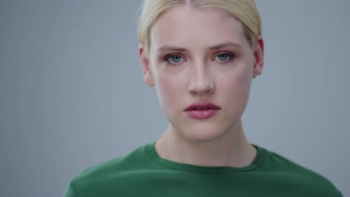 A Contemplative Portrait of a Woman Dressed in a Green Sweater Reflecting Depth and Beauty