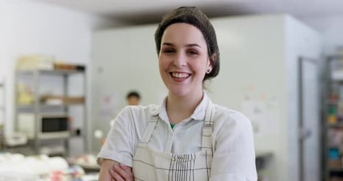 Happy woman, portrait and smile in bakery with employee, apron and working in cafe kitchen