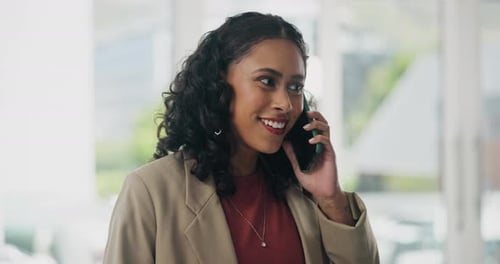 Smiling Woman Talking on Cell Phone in Office