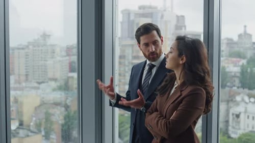 Bearded businessman and woman manager discuss new project close up in office