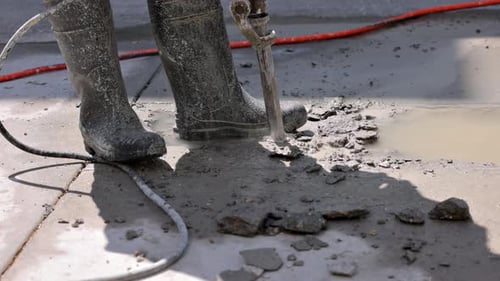 Jackhammer Breaking Concrete in Urban Environment