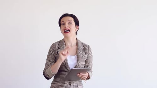 Woman Talking and Gesturing with Tablet