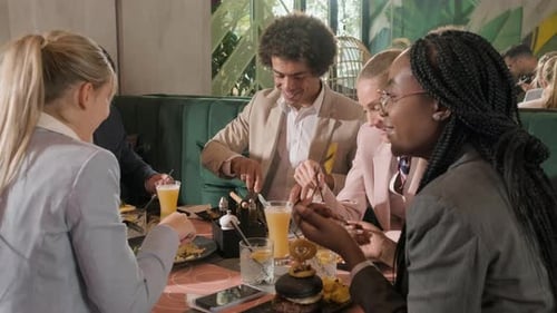 Group of people sitting in a restaurant at a business lunch.