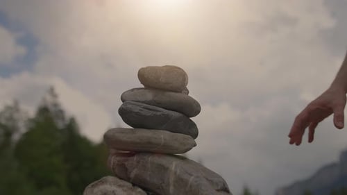 A Man And A Woman Building a Stone Tower Together Outdoors in Nature