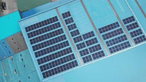 Aerial view of solar cell panels installed on roof of the factory. Go green save the planet