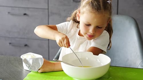 Girl Mixing Ingredients in Bowl for Baking