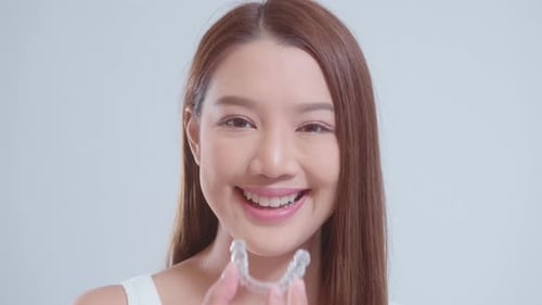Woman Shows Clear Aligner for Straightening Teeth