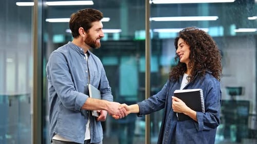 Business Man and Woman Shaking Hands in Modern Office After Business Meeting
