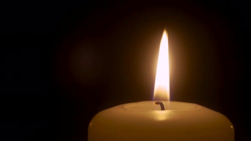 Single Big Yellow Candle Flame Lights and Extinguish By Wind Blowing