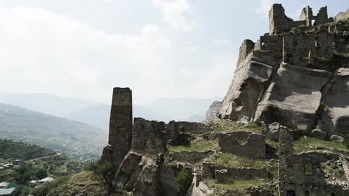 Top view of historical stone ruins on background of mountains