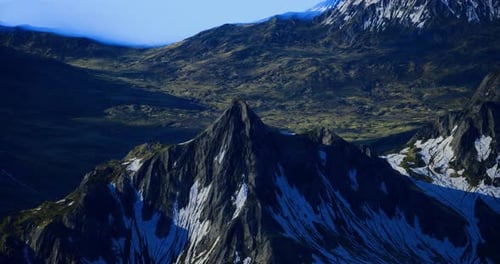 Majestic Mountain Peak Rising Above Lush Valleys in Bright Daylight