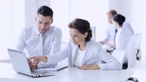Business team discussing project goals at a modern office meeting table