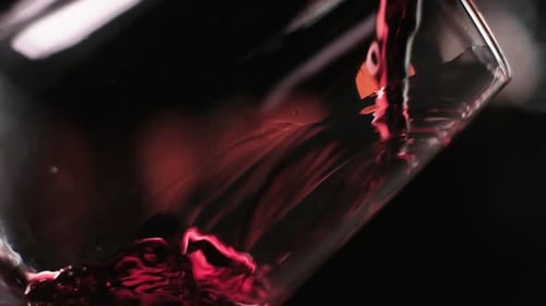 Pouring Red wine into Glass in Slow motion, Extreme Close-up shot
