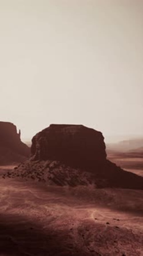 Desert Landscape With Distant Rock Formation