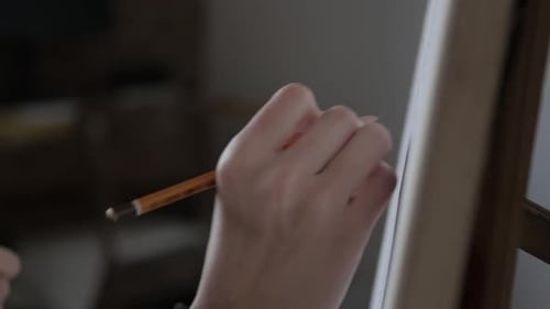 Artist Hand Drawing on Canvas with Pencil