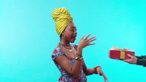 A Vibrant Woman Dressed in Colorful Attire and a Stylish Headwrap Radiating Confidence