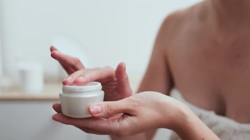 Applying Cream, Busy Woman Slowly Applying Organic Skin Cream In Care Room General View Young